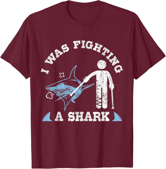 I Was Fighting A Shark Funny Broken Leg Foot Injury Crutches T-Shirt - T-Shirt | Maroon